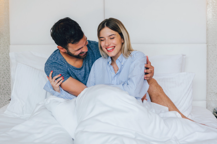 Women happy in bed with parter